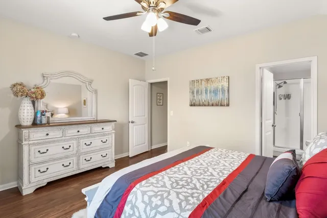 a bedroom with a bed and a dresser