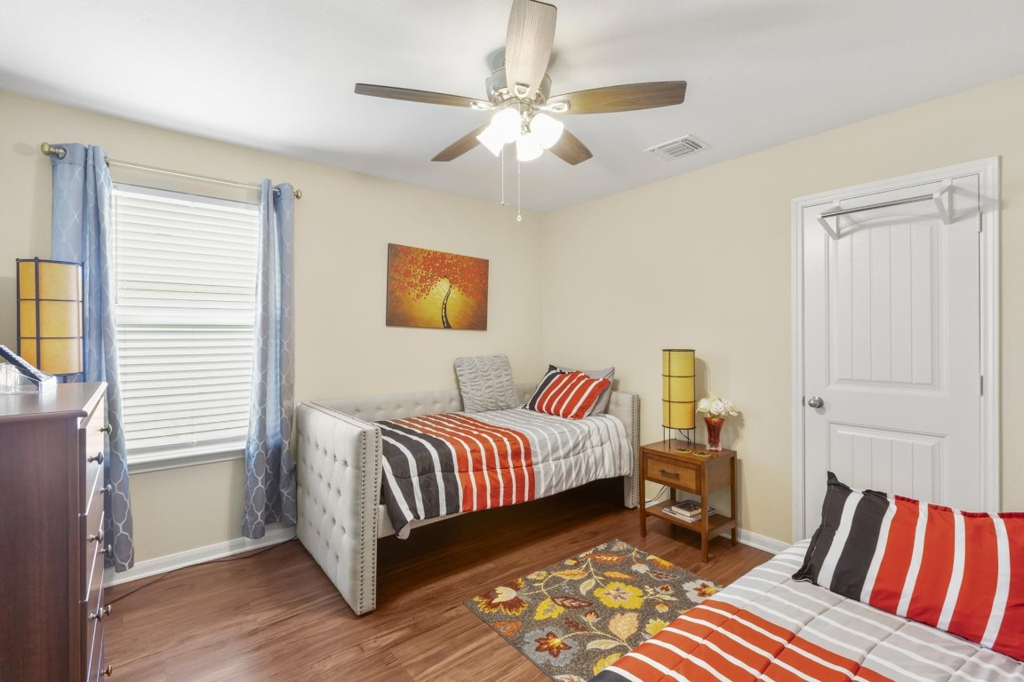 172 Alpha Kyle, TX 78640 - Photo 15 of 21 a bedroom with a bed and a chandelier