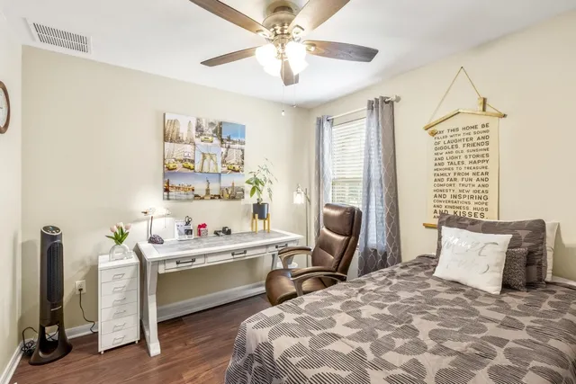 a bed room with a bed a dresser and a window