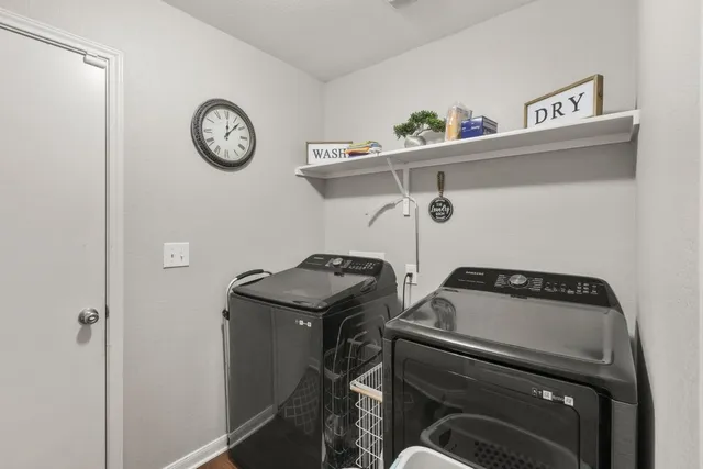 a utility room with a stove and a refrigerator