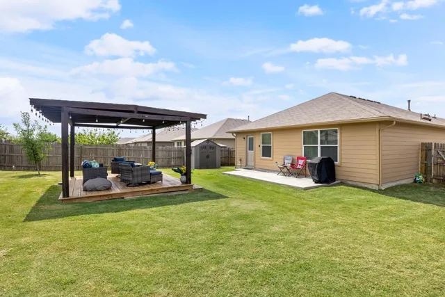 a view of a house with backyard sitting area and garden