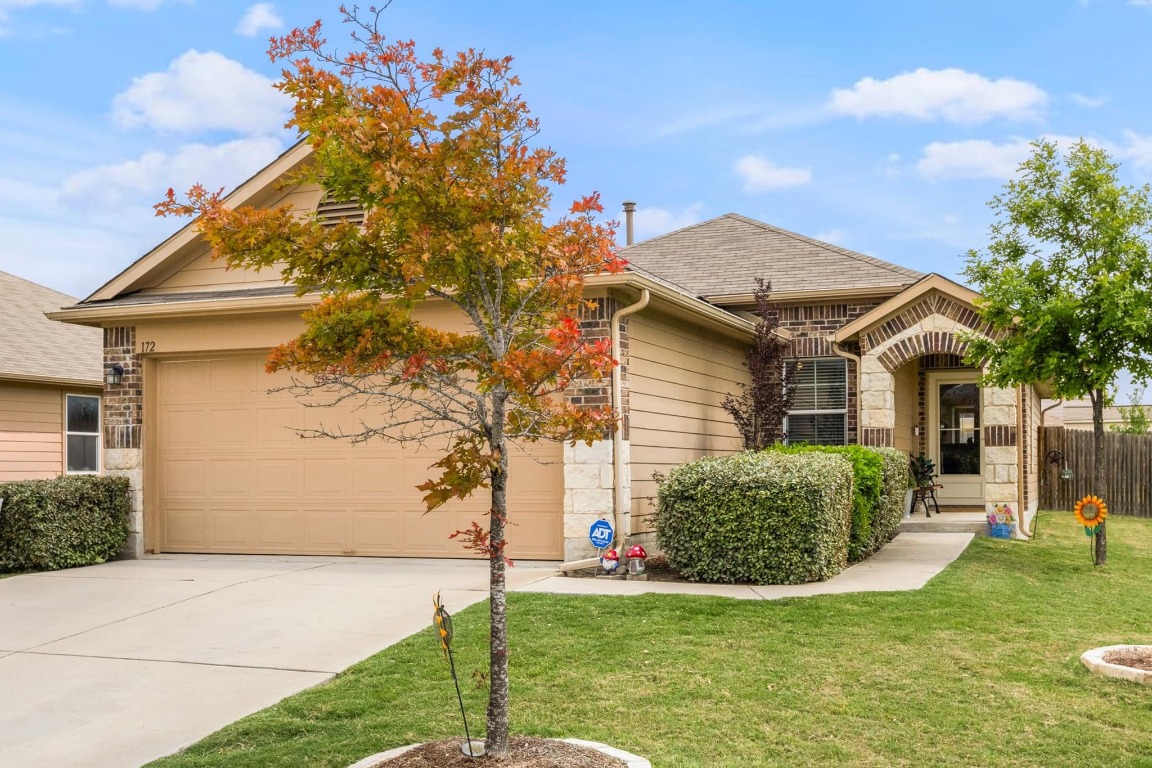 172 Alpha Kyle, TX 78640 - Photo 2 of 21 a front view of a house with a garden