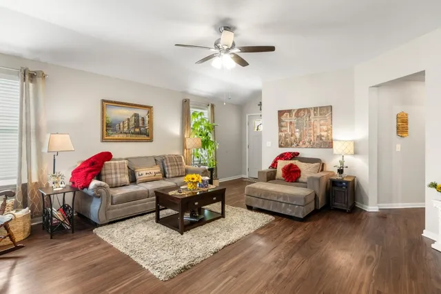 a living room with furniture and wooden floor