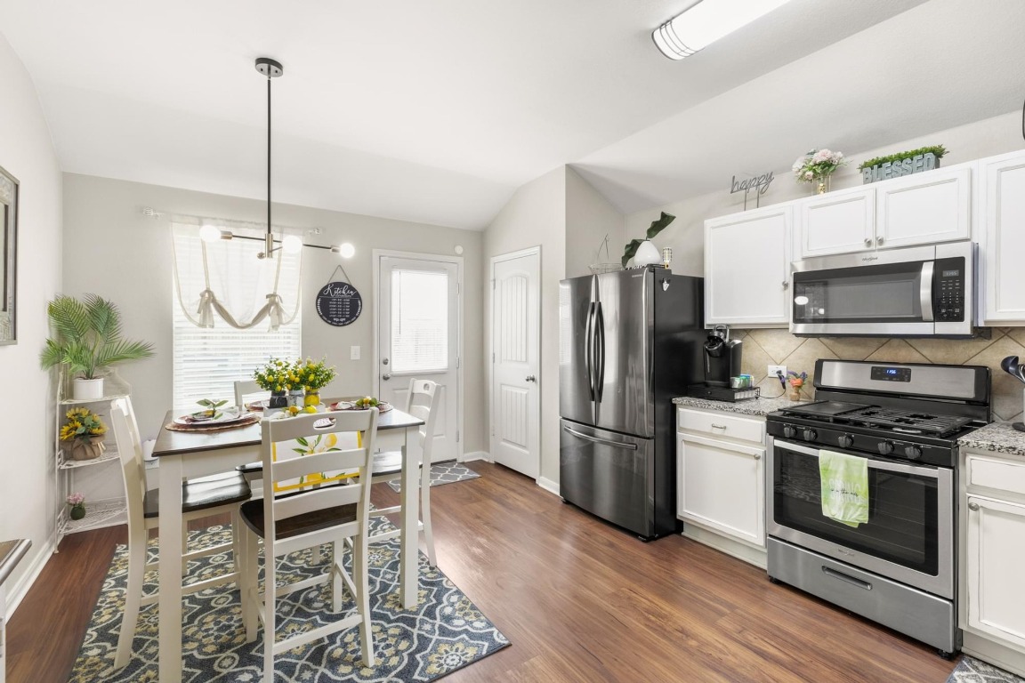 172 Alpha Kyle, TX 78640 - Photo 8 of 21 a kitchen with stainless steel appliances a stove a refrigerator and a dining table