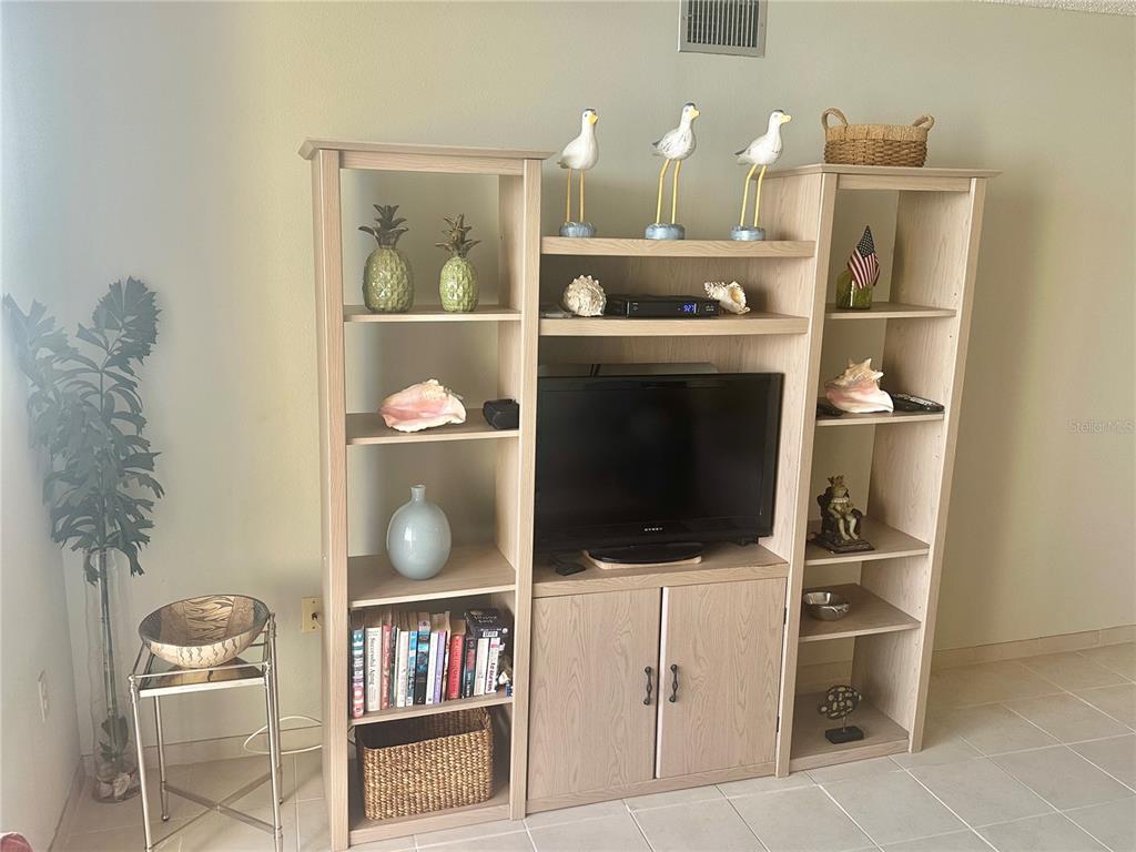 6035 Sea Ranch Drive, Unit 508 Hudson, FL 34667 - Photo 14 of 69 a room with furniture and a flat screen tv