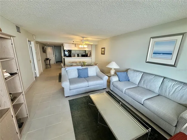 a bed sitting in a bedroom next to a lamp