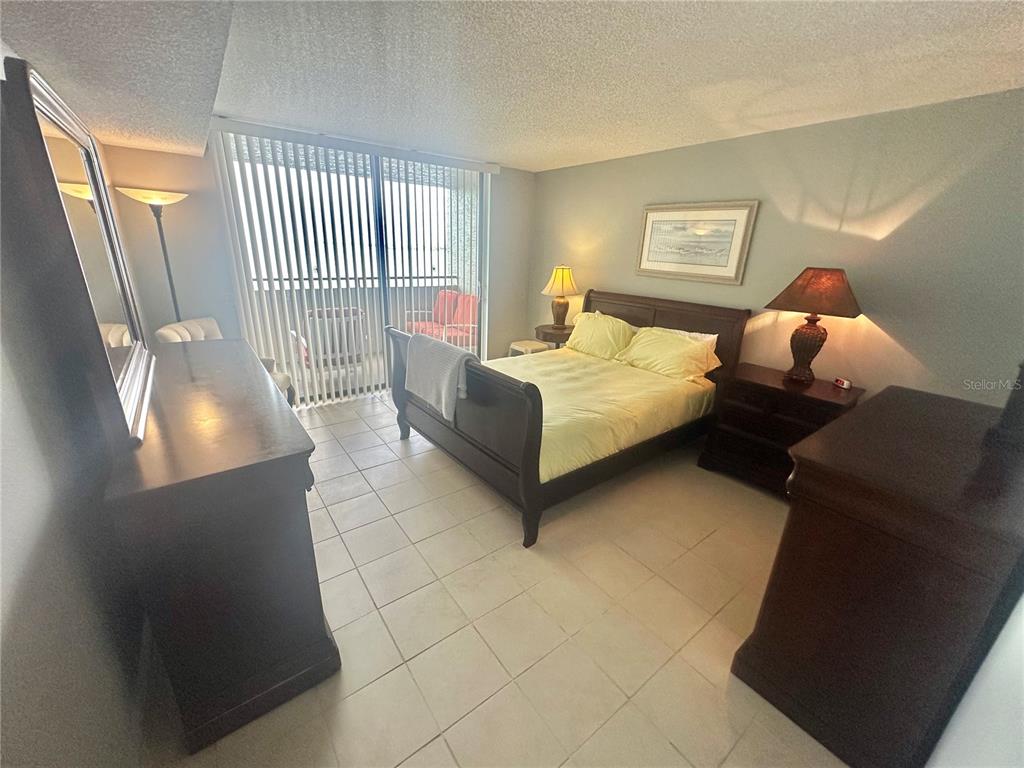 6035 Sea Ranch Drive, Unit 508 Hudson, FL 34667 - Photo 16 of 69 a bedroom with bed and window