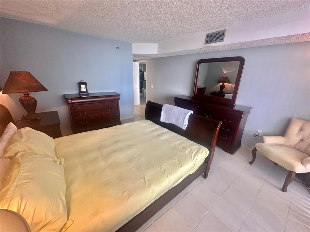 6035 Sea Ranch Drive, Unit 508 Hudson, FL 34667 - Photo 17 of 69 a bedroom with a bed and a mirror