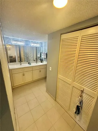 a bathroom with a sink a mirror and a shower