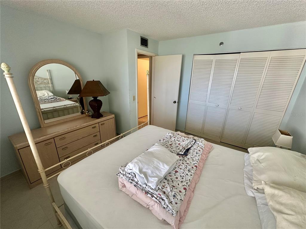 6035 Sea Ranch Drive, Unit 508 Hudson, FL 34667 - Photo 23 of 69 a bedroom with a bed and a dresser