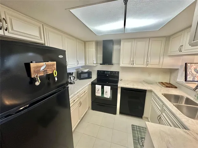 a kitchen with cabinets and appliances