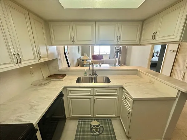 a kitchen with stainless steel appliances granite countertop a sink and a stove