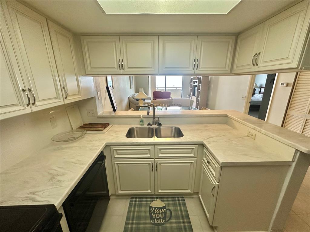 6035 Sea Ranch Drive, Unit 508 Hudson, FL 34667 - Photo 8 of 69 a kitchen with a sink a stove and cabinets