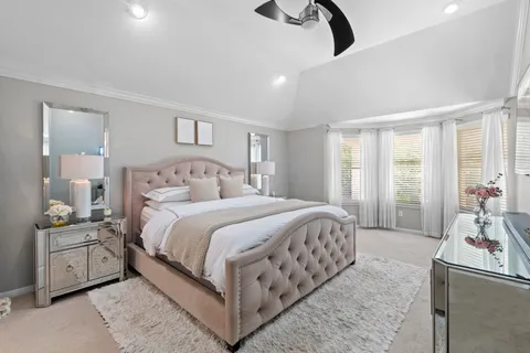 a bedroom with a bed and a couch