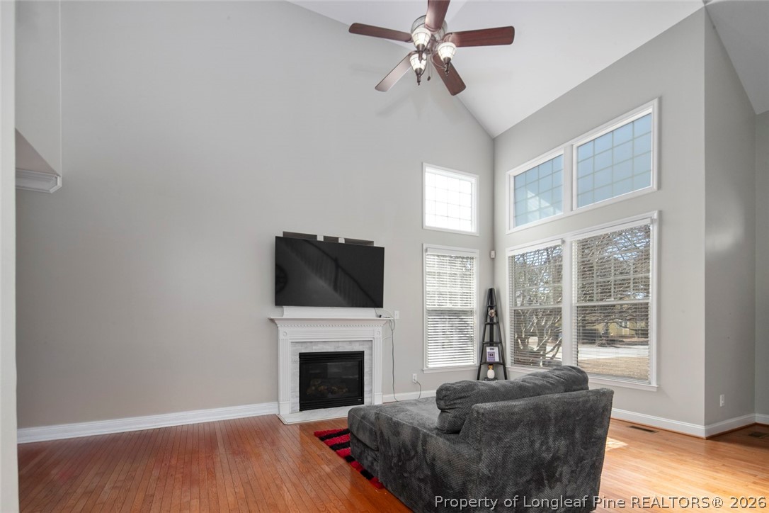 98 Cottswold Lane Spring Lake, NC 28390 - Photo 15 of 30 a living room with furniture a fireplace and a flat screen tv