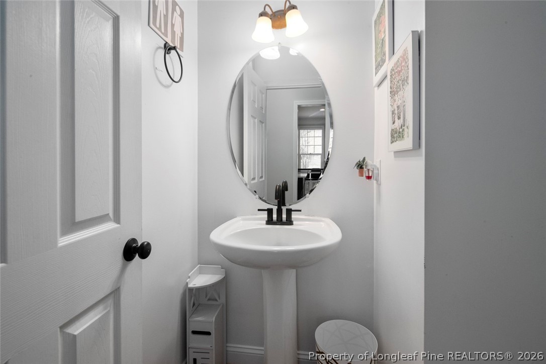 98 Cottswold Lane Spring Lake, NC 28390 - Photo 21 of 30 a bathroom with a sink a light fixture and a mirror
