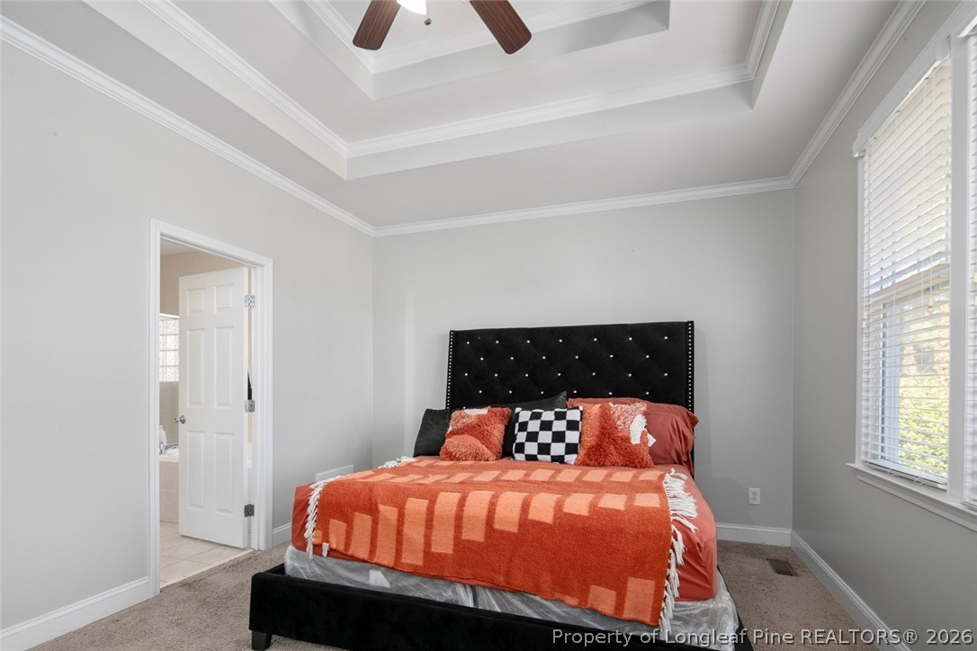 98 Cottswold Lane Spring Lake, NC 28390 - Photo 23 of 30 a bed sitting in a bedroom next to a window