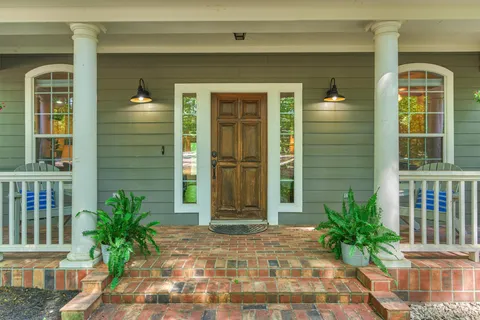 a front view of a house with a garden