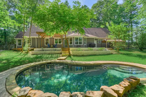 a swimming pool with outdoor seating and yard