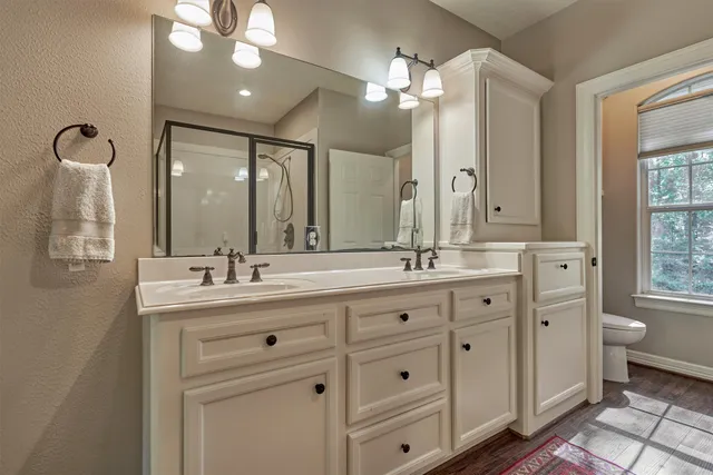 a bathroom with a shower sink and mirror