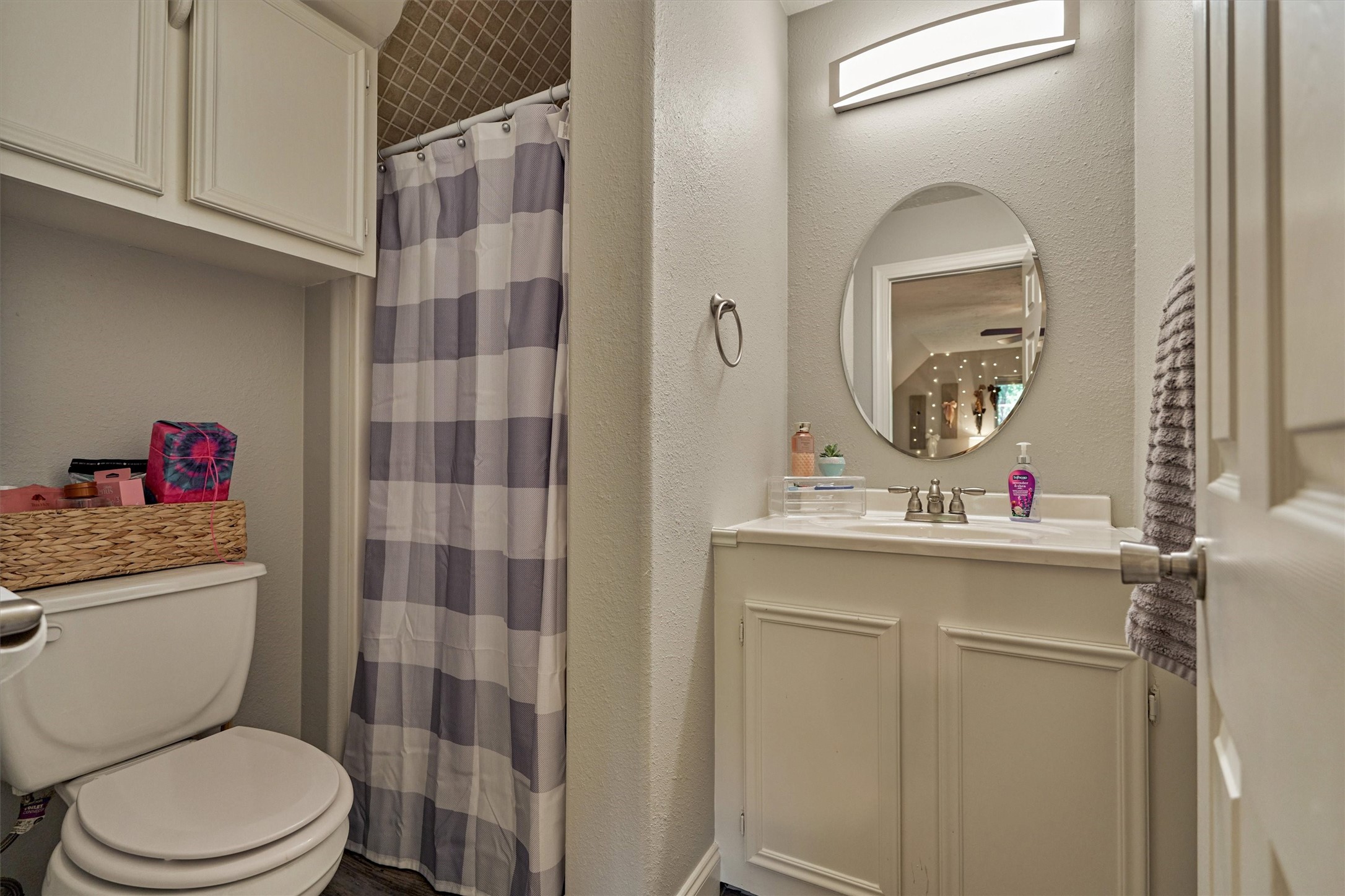 28694 West Fm 1097 Road Montgomery, TX 77356 - Photo 42 of 50 a bathroom with a toilet a sink and a mirror