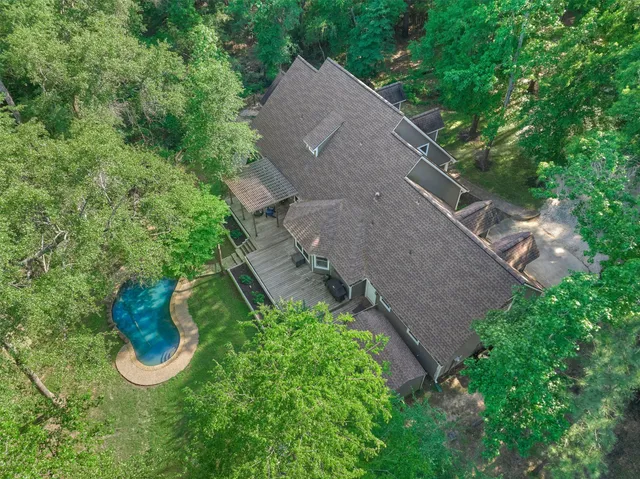 an aerial view of a house with garden space and street view