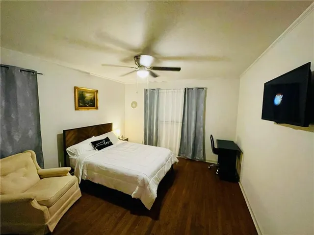 a bedroom with a bed and a television