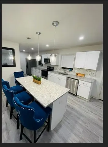 a large kitchen with a table and chairs