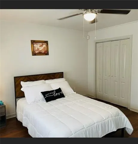 a bedroom with a bed and a night stand