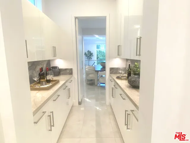 a bedroom with furniture and a large window