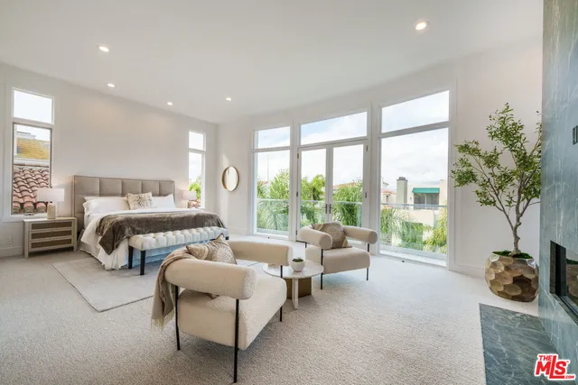 a large bathroom with a granite countertop double vanity sink a large mirror and a shower