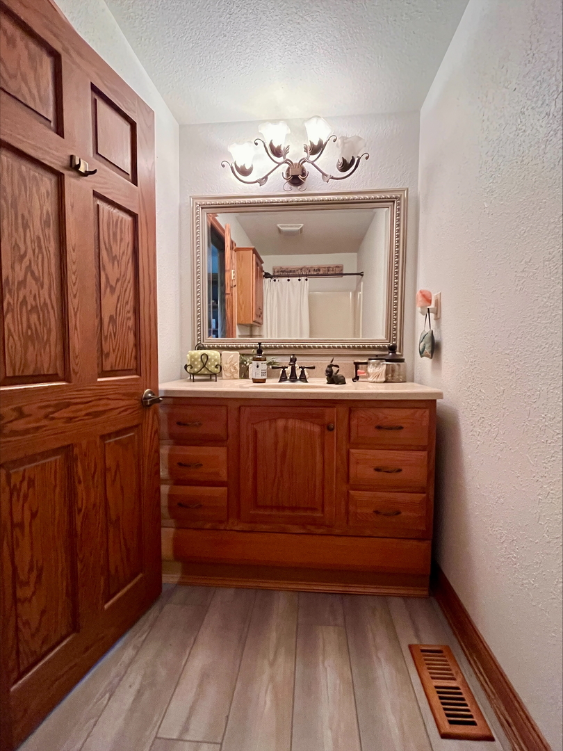 1116 East 2300 North Road Danforth, IL 60930 - Photo 28 of 32 a room with a mirror and a sink