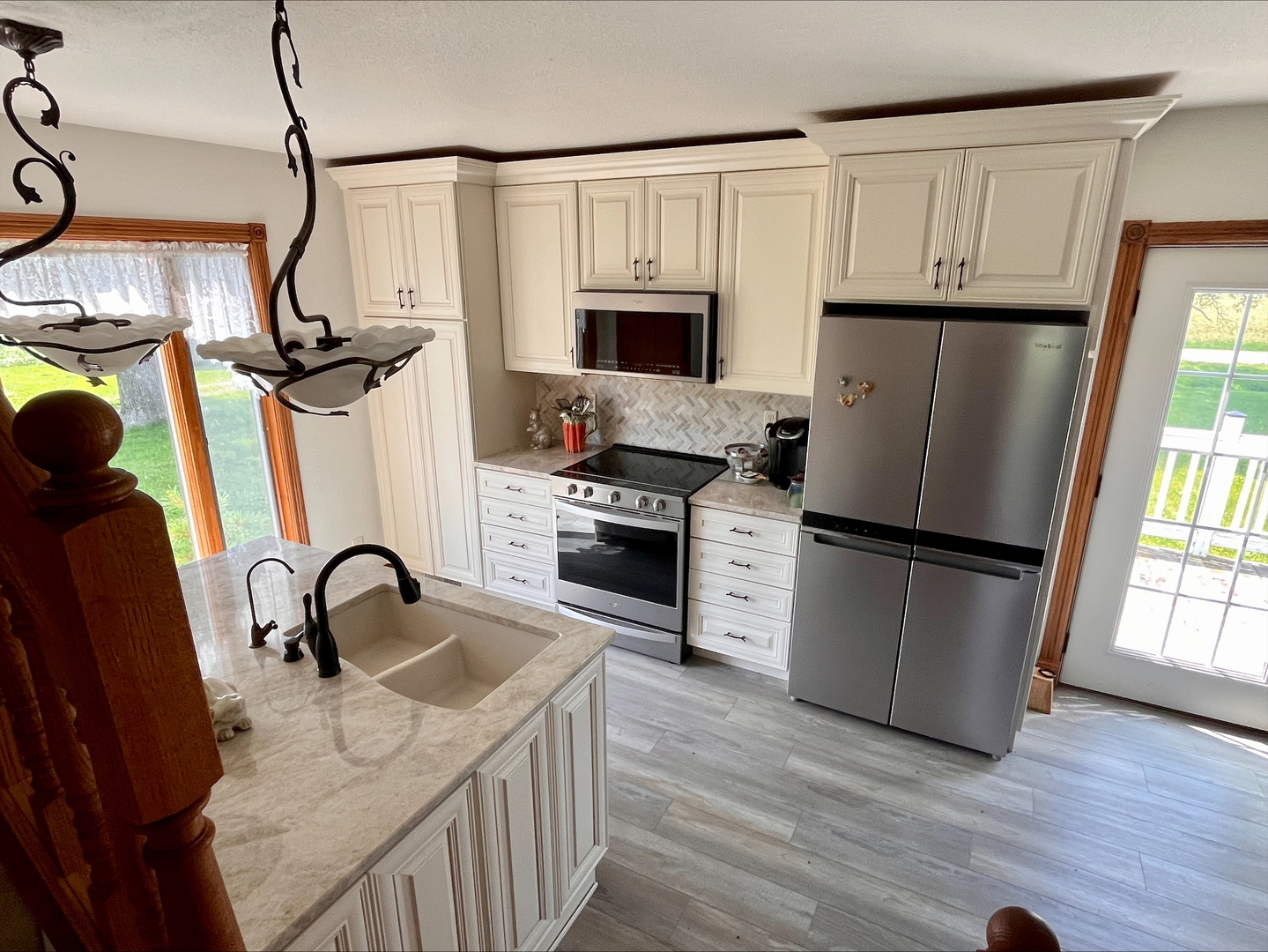 1116 East 2300 North Road Danforth, IL 60930 - Photo 8 of 32 a kitchen with refrigerator a stove a sink and white cabinets with wooden floor