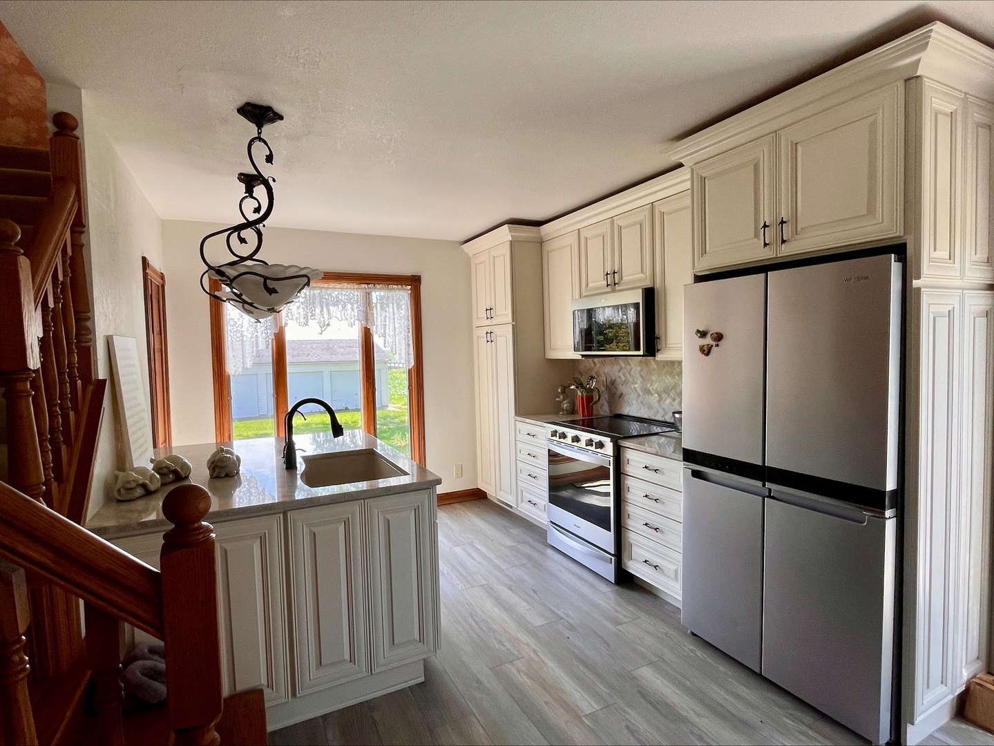 1116 East 2300 North Road Danforth, IL 60930 - Photo 9 of 32 a kitchen with stainless steel appliances a refrigerator sink and wooden floor