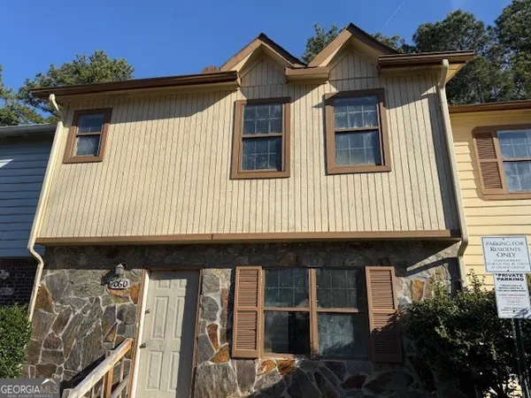 a front view of a house with garage
