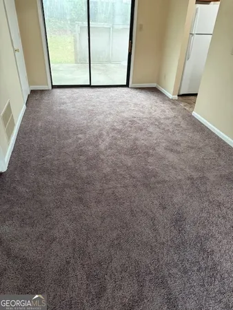 a view of a big room with sliding door and wooden floor