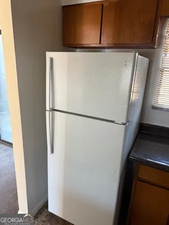 a white refrigerator freezer and a stove sitting inside of a refrigerator