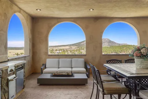 a living room with furniture and a floor to ceiling window