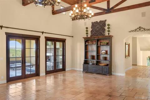 a view of a livingroom with furniture and chandelier fan