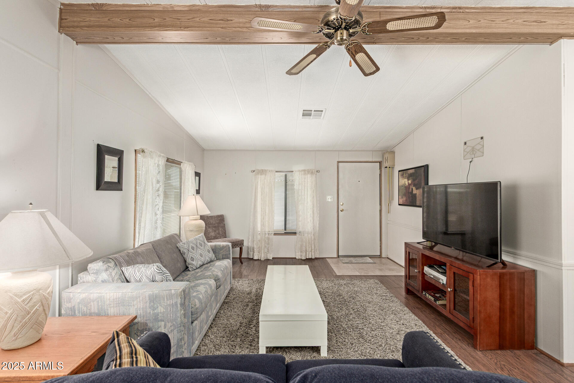 301 South Signal Butte Road, Unit 706 Apache Junction, AZ 85120 - Photo 13 of 51 a living room with furniture and a flat screen tv