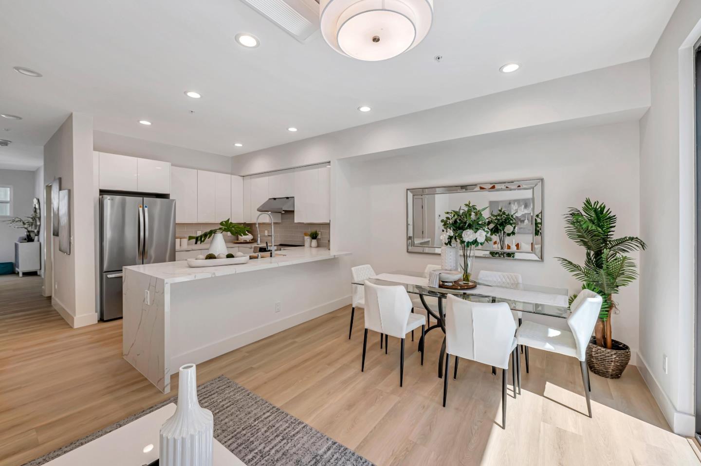 1982 Montecito Avenue Mountain View, CA 94043 - Photo 6 of 30 a kitchen with white cabinets and stainless steel appliances