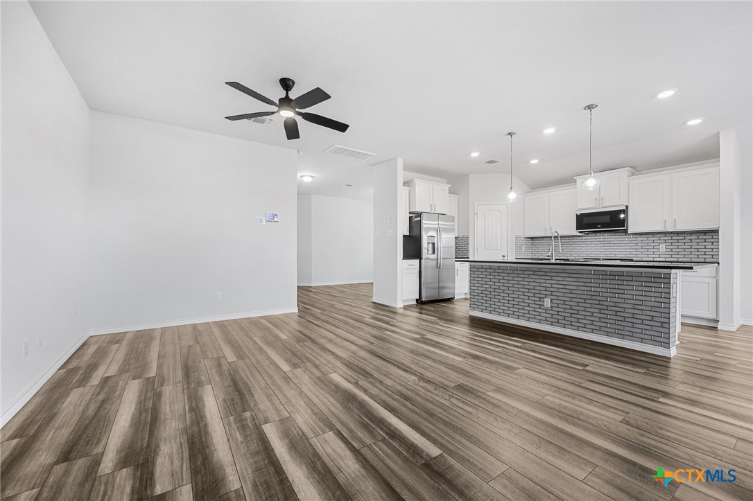 6166 Lavaca Drive Belton, TX 76513 - Photo 13 of 41 a view of a kitchen with a sink and wooden floor