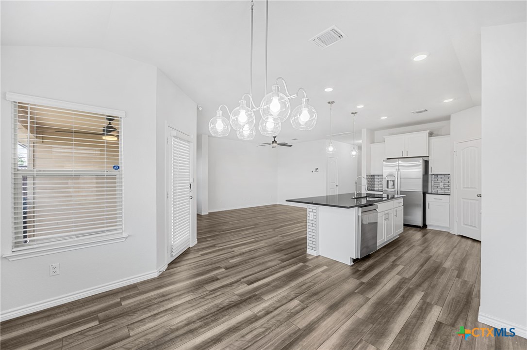 6166 Lavaca Drive Belton, TX 76513 - Photo 18 of 41 a large kitchen with granite countertop a large counter top and stainless steel appliances