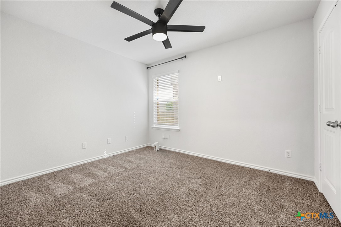 6166 Lavaca Drive Belton, TX 76513 - Photo 28 of 41 an empty room with a window and a ceiling fan