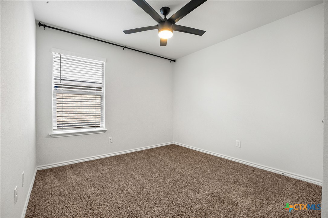 6166 Lavaca Drive Belton, TX 76513 - Photo 30 of 41 an empty room with a window and a ceiling fan