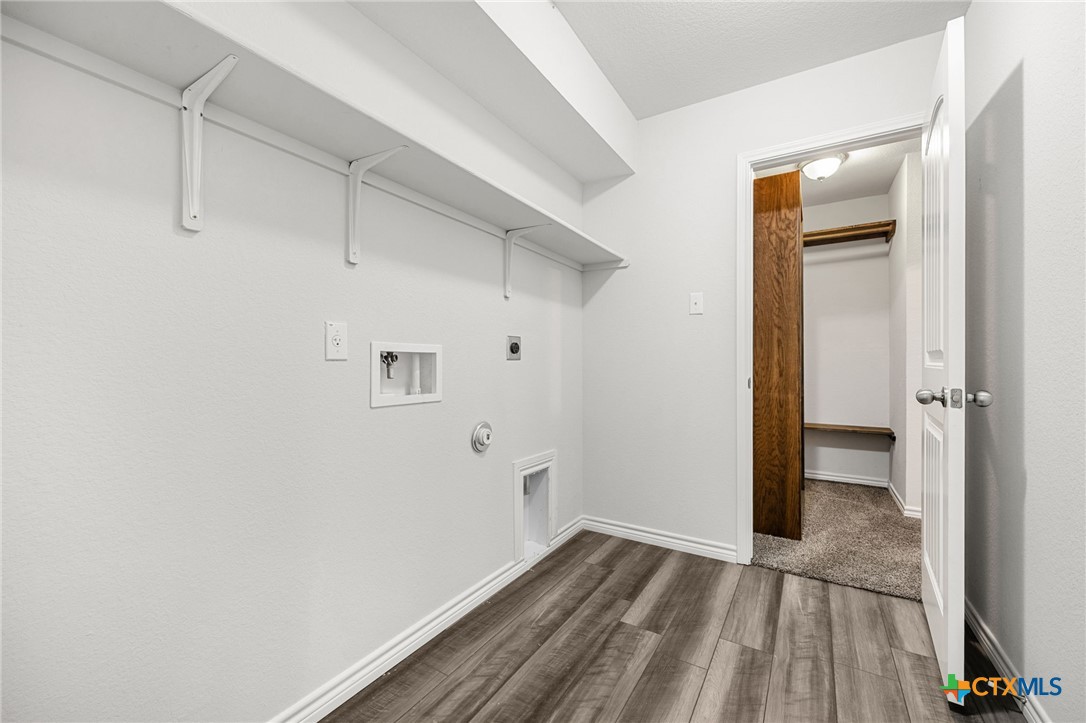 6166 Lavaca Drive Belton, TX 76513 - Photo 31 of 41 a view of a hallway with wooden floor and a bathroom