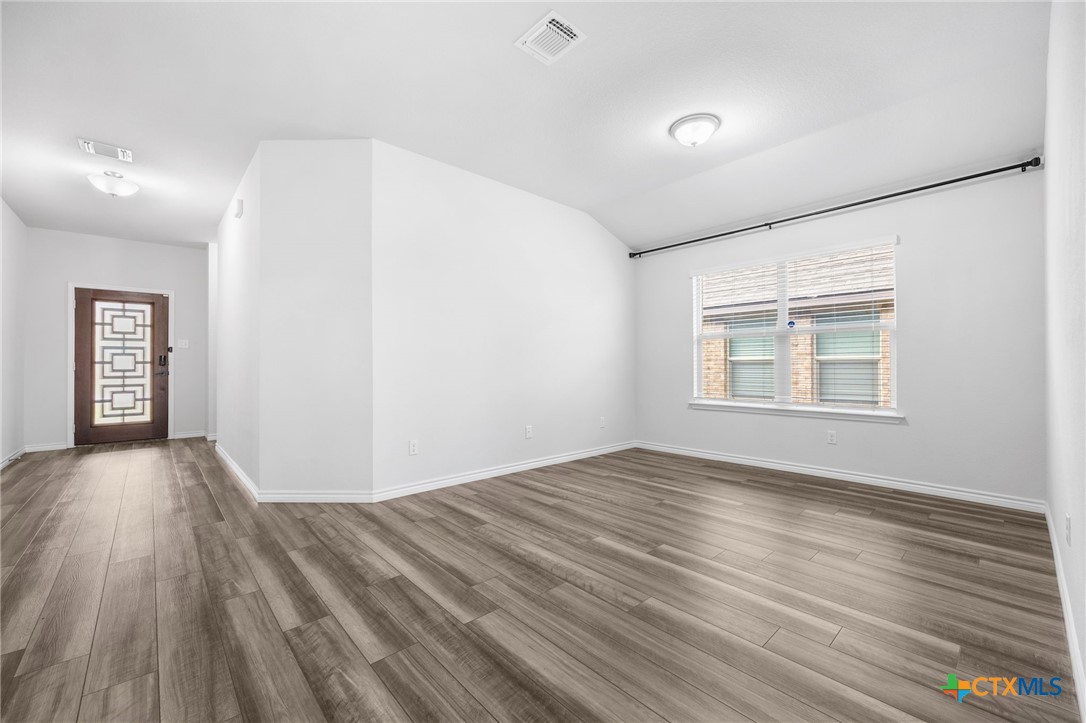 6166 Lavaca Drive Belton, TX 76513 - Photo 7 of 41 a view of an empty room with wooden floor and a window