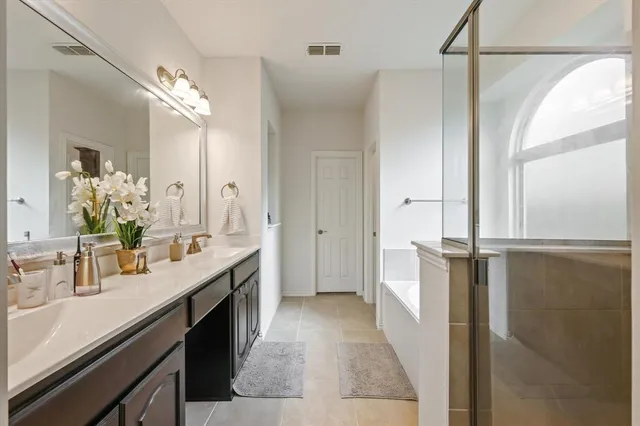 a bathroom with a double vanity sink and mirror