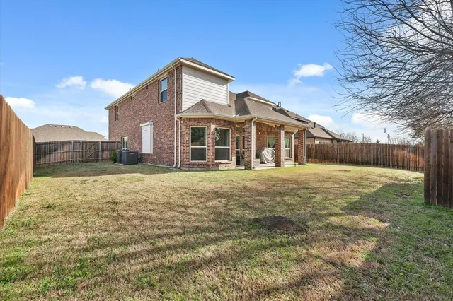 an aerial view of a house with a mountain
