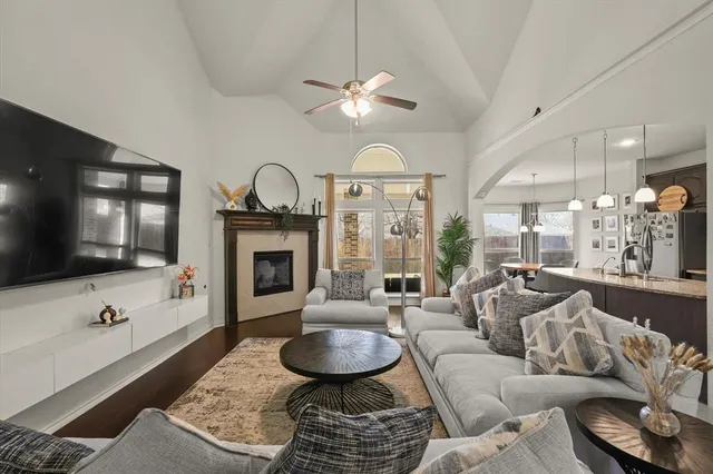 a living room with furniture a large window and a fireplace